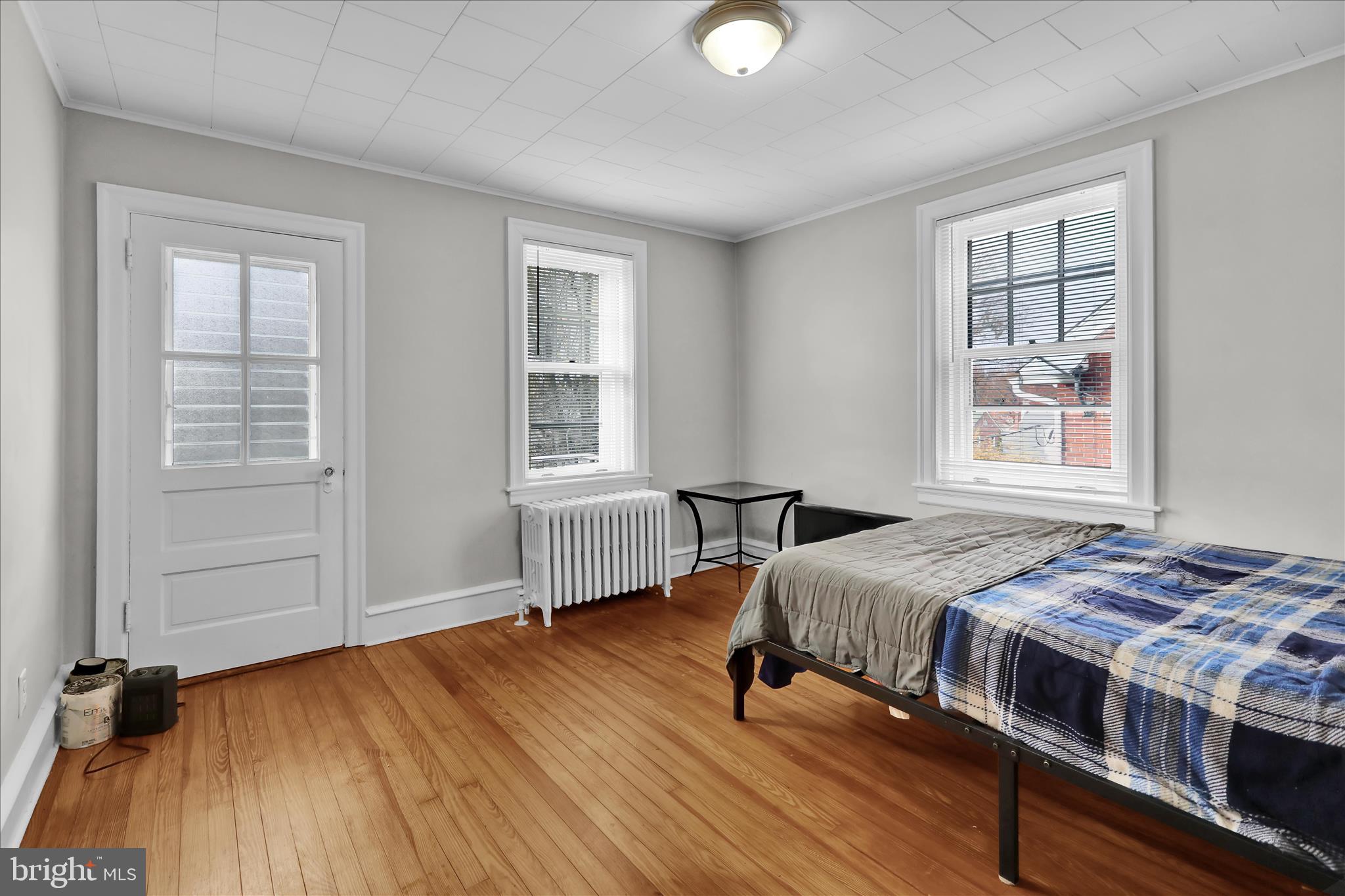 1722 Olive Street Reading, PA 19604 - Photo 16 of 31 a bedroom with a bed and wooden floor