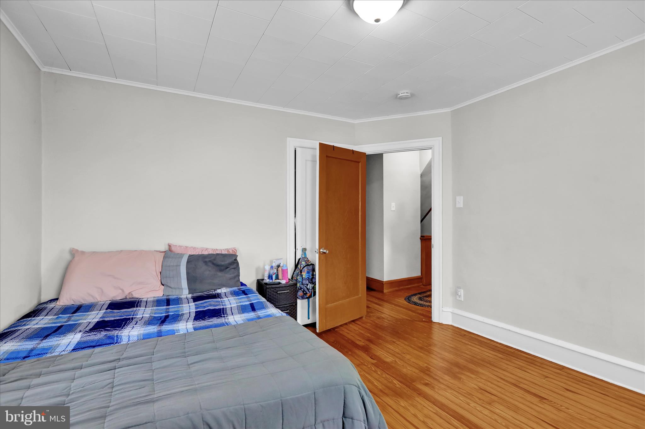 1722 Olive Street Reading, PA 19604 - Photo 17 of 31 a bedroom with a bed and wooden floor