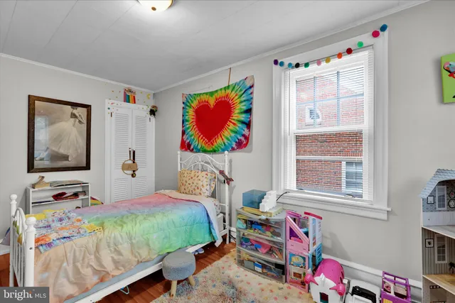 a bedroom that has a bed and a chair in it