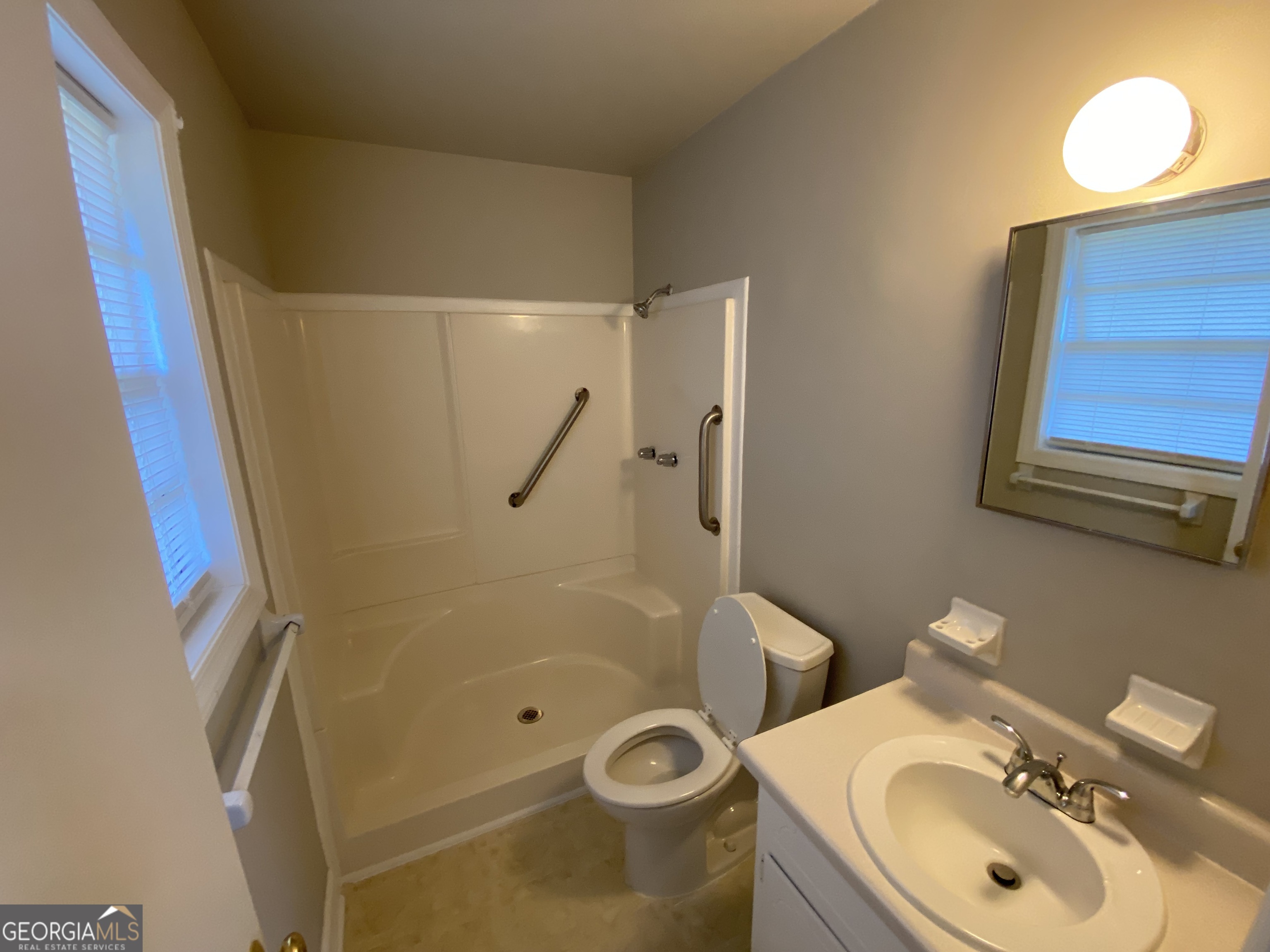 6092 Prestige Valley Road Morrow, GA 30260 - Photo 8 of 11 a bathroom with a granite countertop sink toilet and a mirror