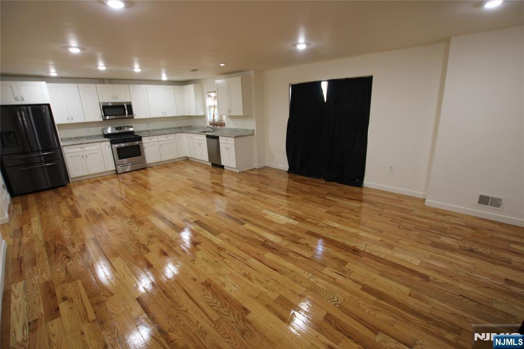 a view of kitchen with refrigerator and window