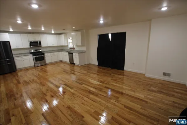 a view of kitchen with refrigerator and window