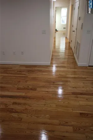 a view of a room with wooden floor