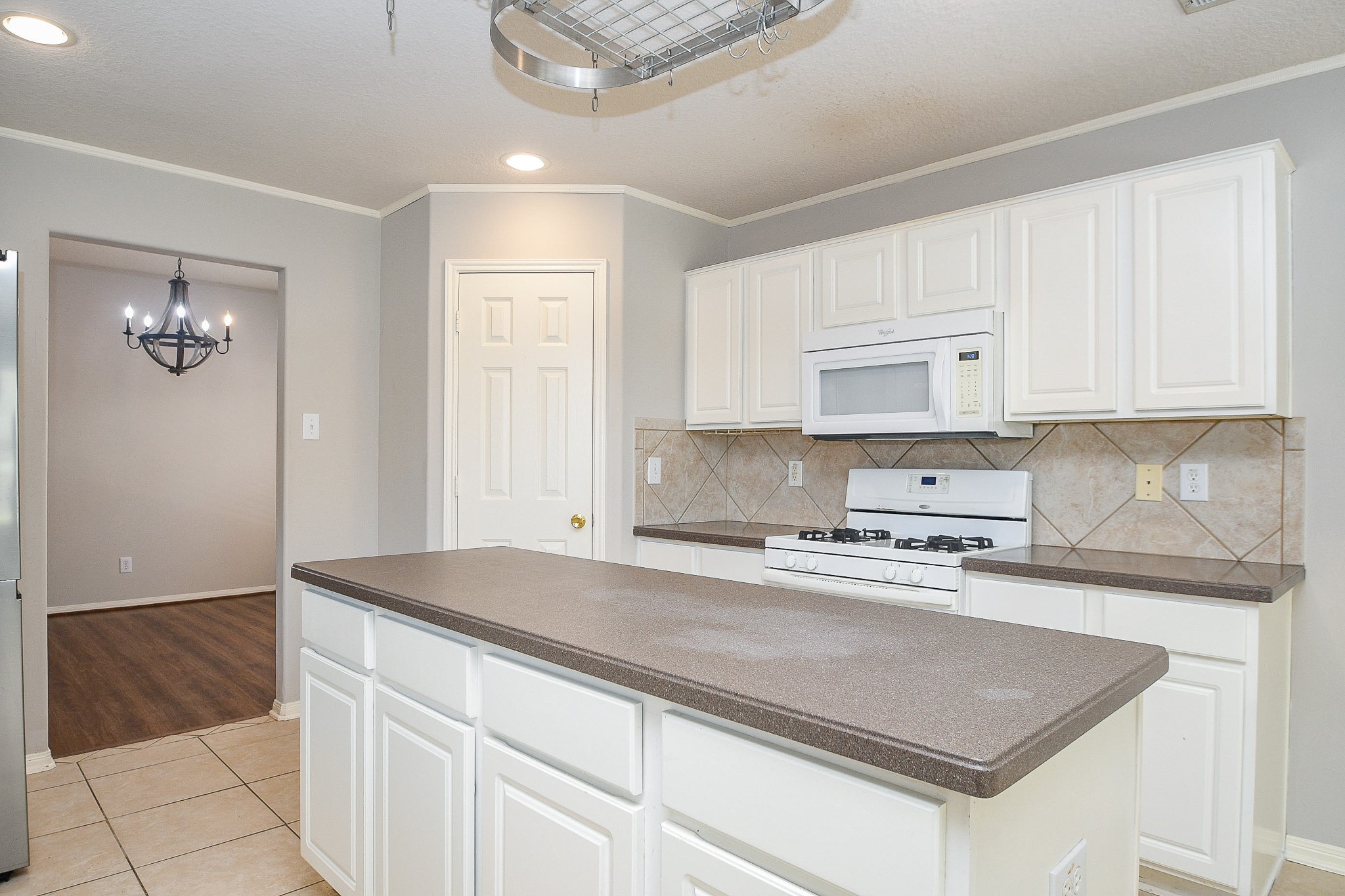 707 New Pines Drive Spring, TX 77373 - Photo 11 of 33 a kitchen with granite countertop a sink a stove and cabinets