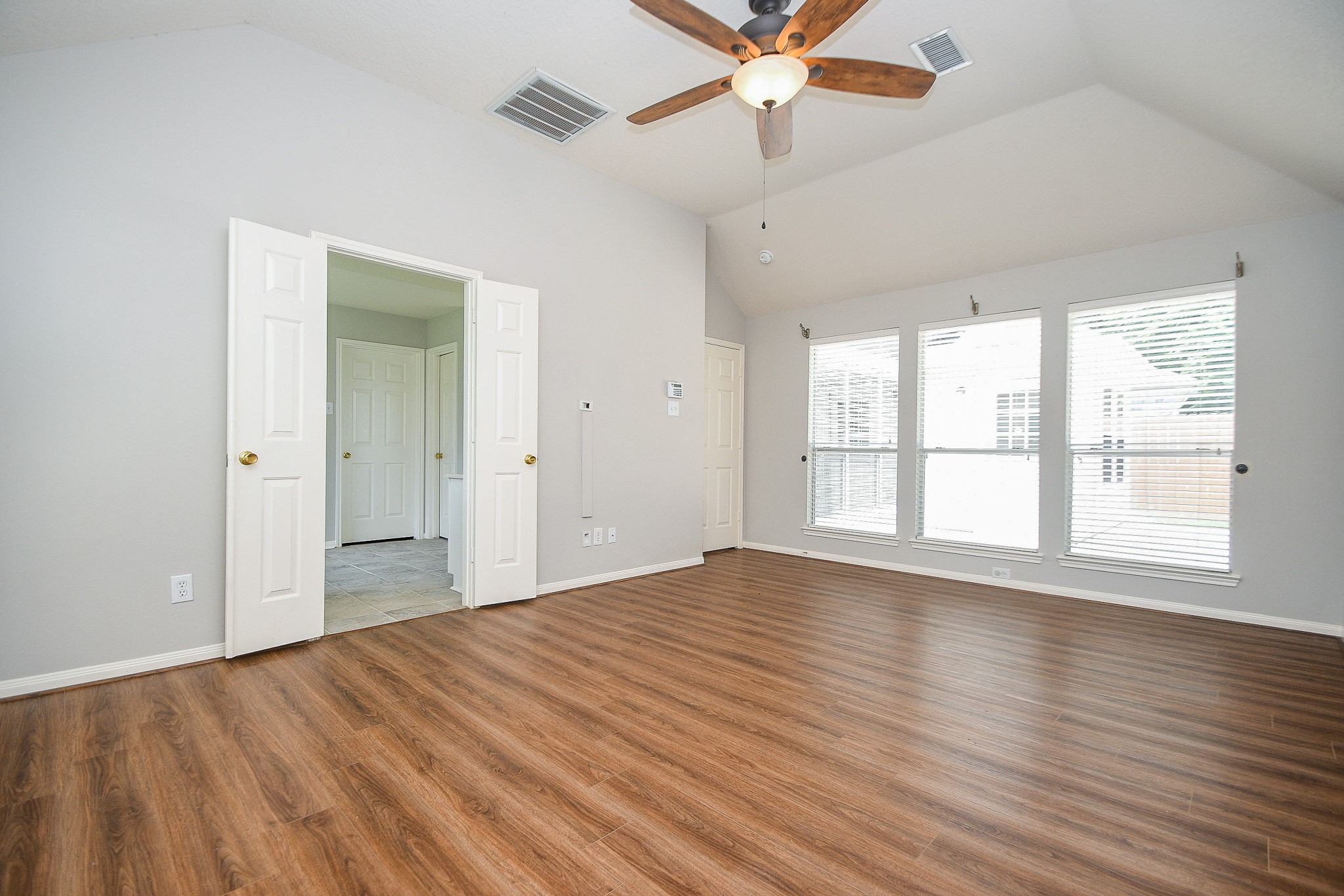 707 New Pines Drive Spring, TX 77373 - Photo 15 of 33 a view of an empty room with wooden floor and a window