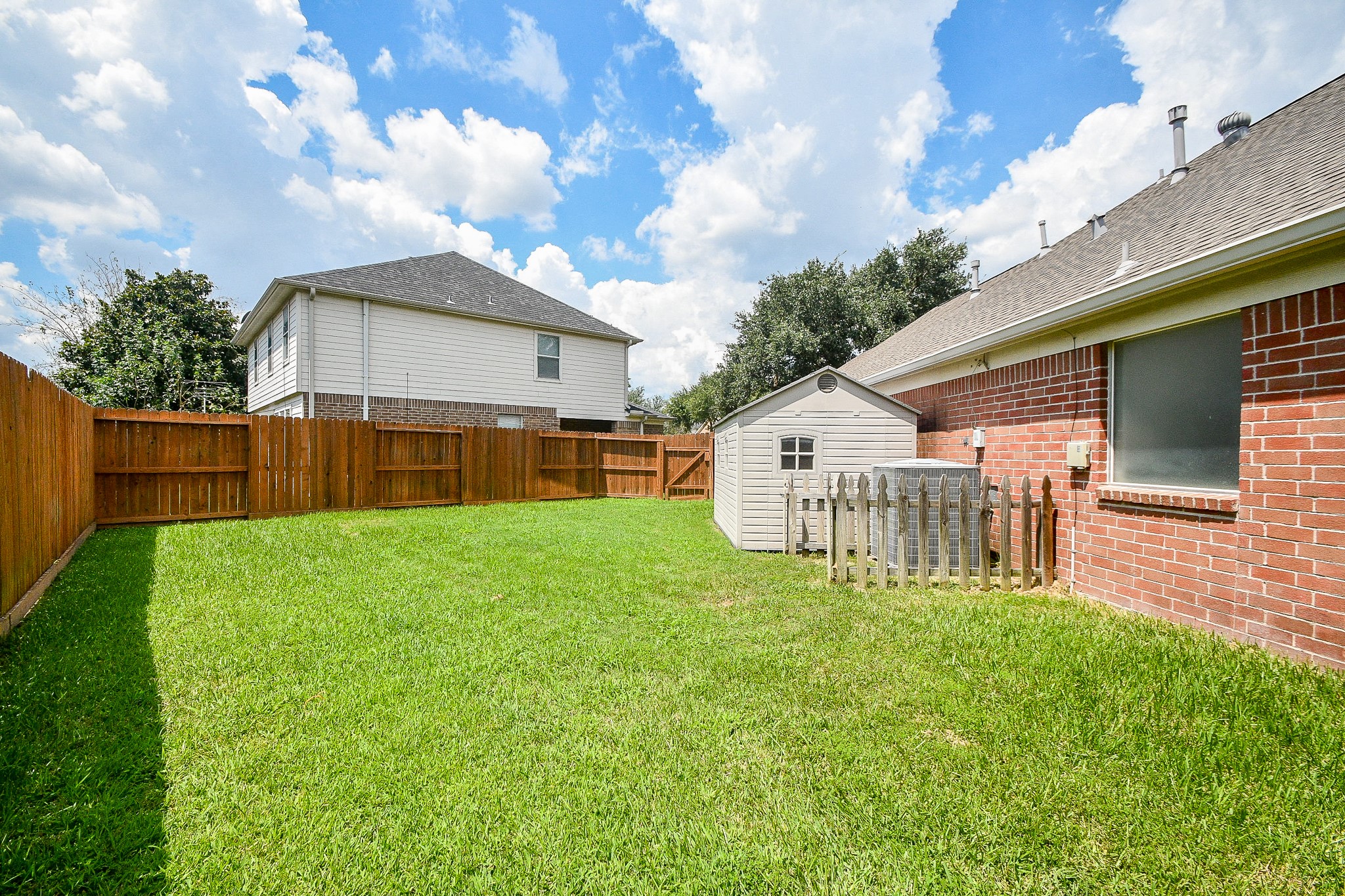 707 New Pines Drive Spring, TX 77373 - Photo 30 of 33 a view of a house with a yard and a fountain