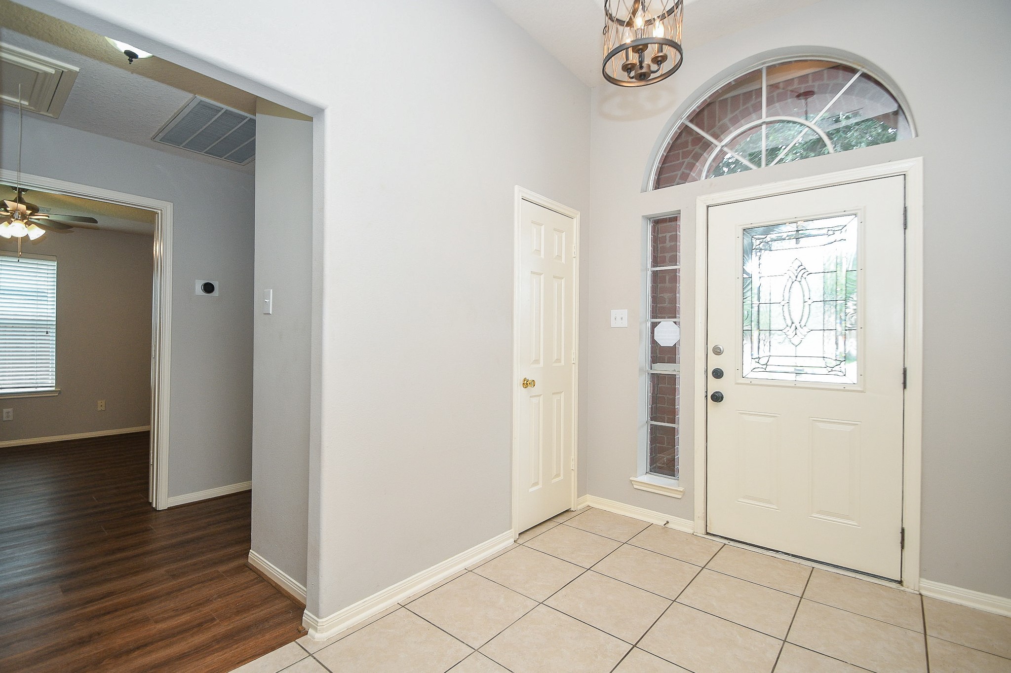 707 New Pines Drive Spring, TX 77373 - Photo 5 of 33 an empty room with wooden floor fan and windows