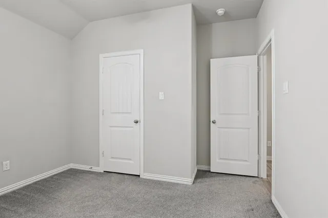 a bathroom with a granite countertop double vanity sink and shower