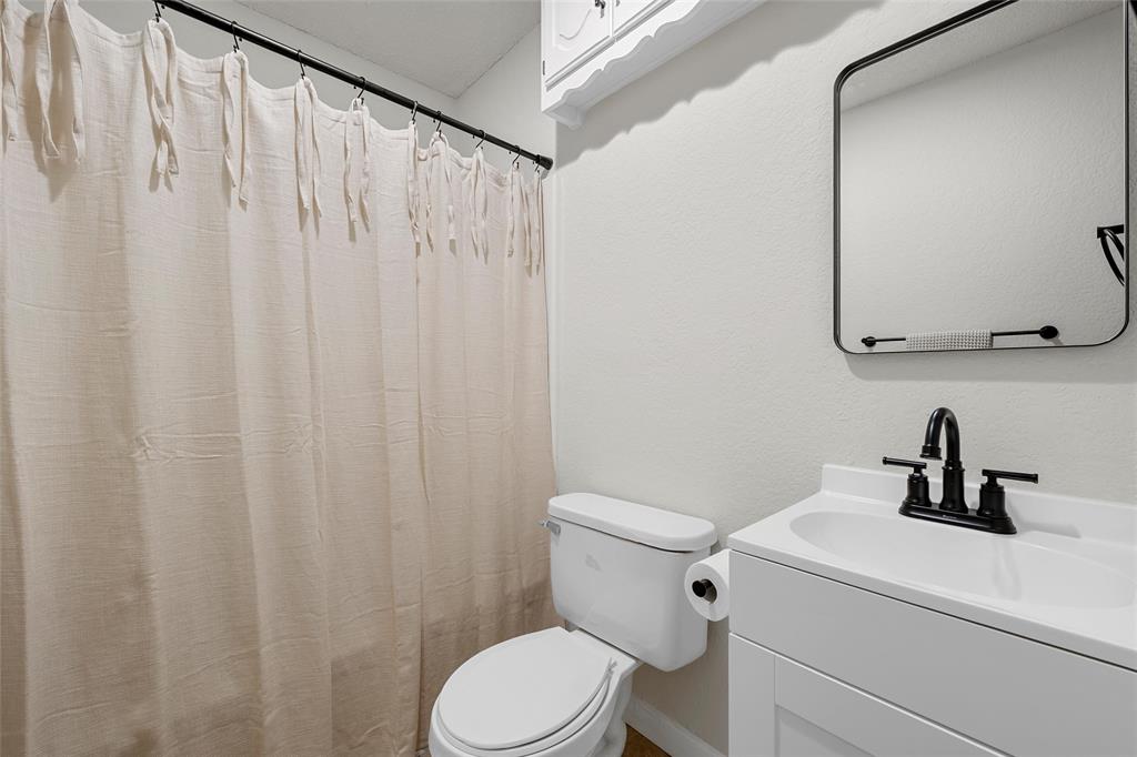 3000 North 15th A Street Waco, TX 76708 - Photo 18 of 24 a white toilet sitting next to a bathroom sink