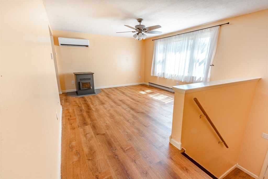 16 Meadow Road Ware, MA 01082 - Photo 6 of 24 a view of a livingroom with a hardwood and a ceiling fan