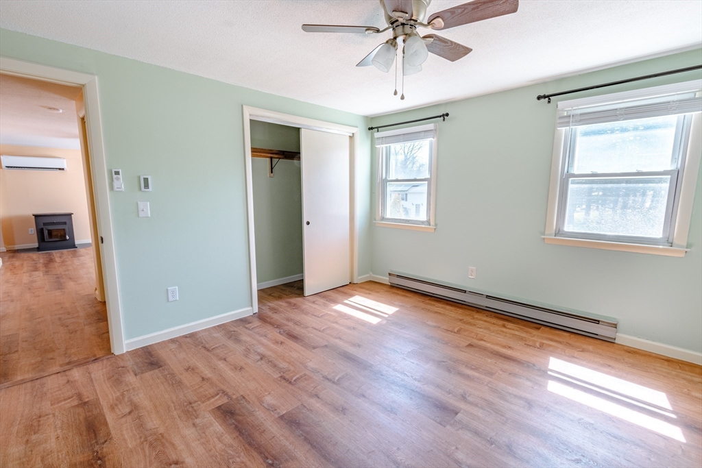 16 Meadow Road Ware, MA 01082 - Photo 8 of 24 a view of an empty room with wooden floor and a window