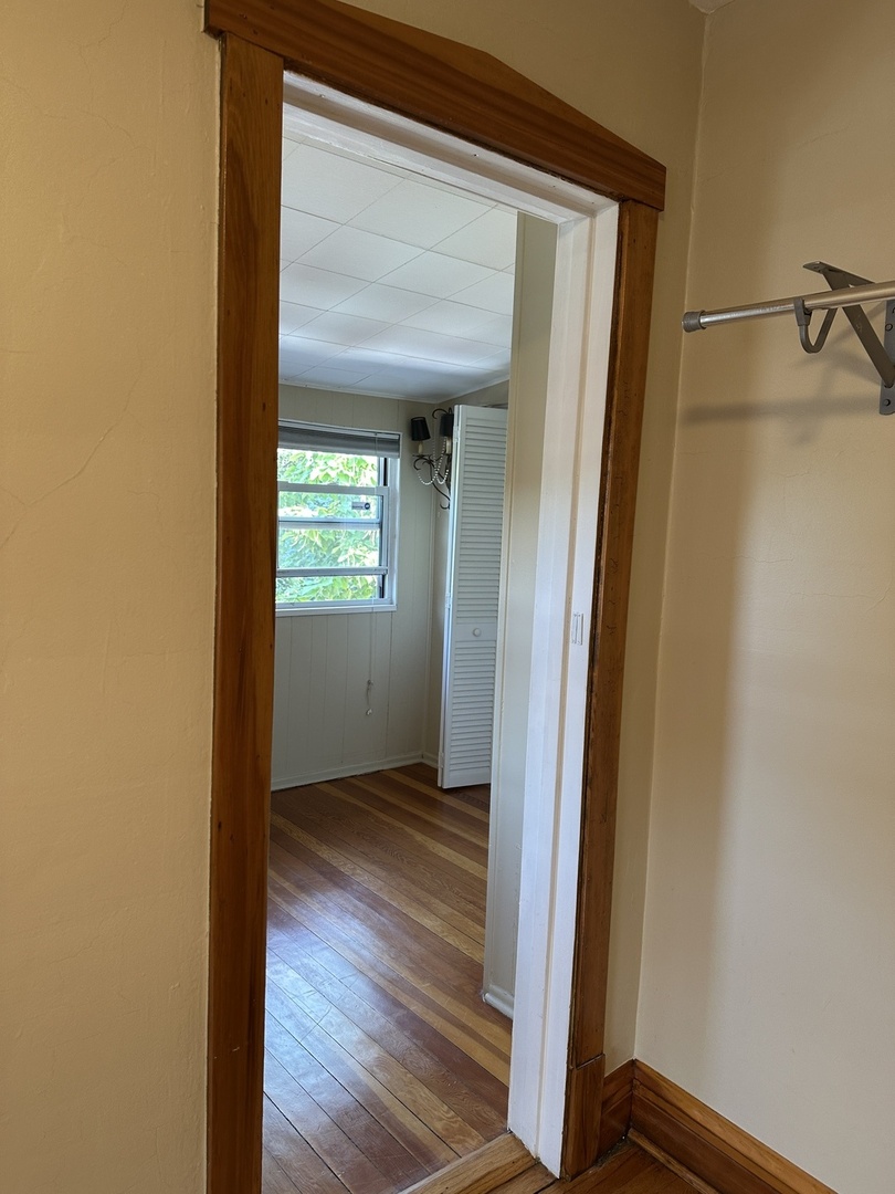 192 Waubansee Road Riverside, IL 60546 - Photo 14 of 19 a view of an empty room with wooden floor and a window