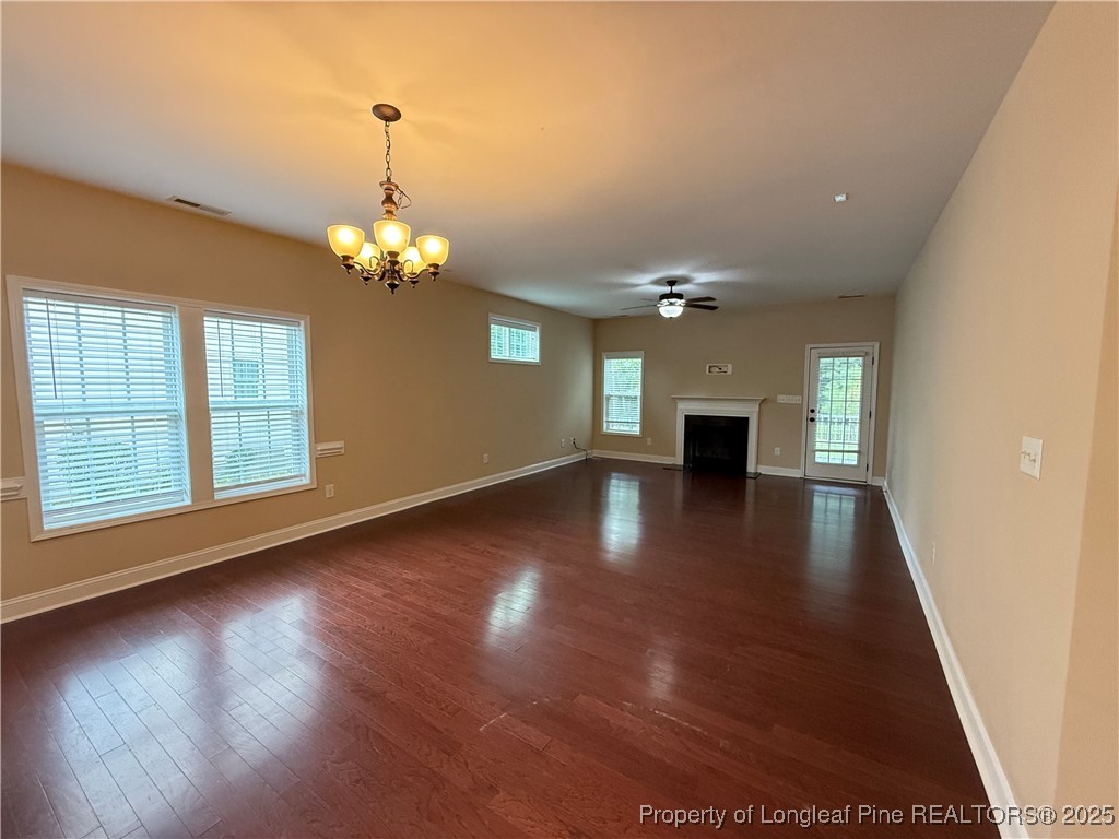 Undisclosed Address Spring Lake, NC 28390 - Photo 8 of 22 a view of a livingroom with wooden floor and a ceiling fan