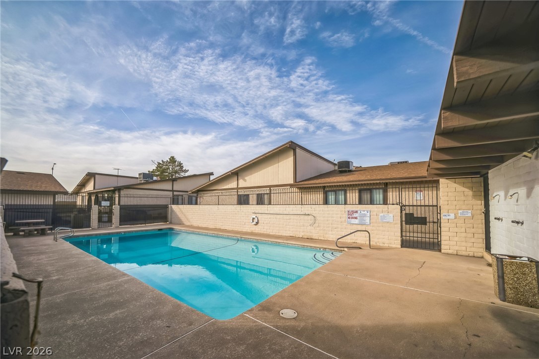 5733 Smoke Ranch Road, Unit D Las Vegas, NV 89108 - Photo 13 of 14 Community pool featuring a patio