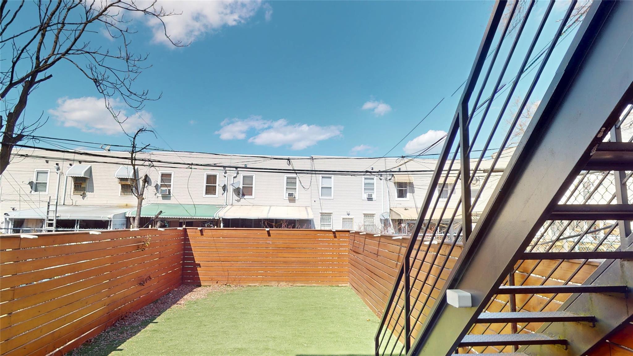 235 Sumpter Street Brooklyn, NY 11233 - Photo 6 of 7 View of yard featuring a fenced backyard and a residential view