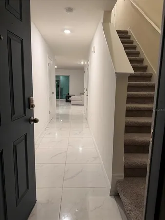a view of entryway and hall with wooden floor