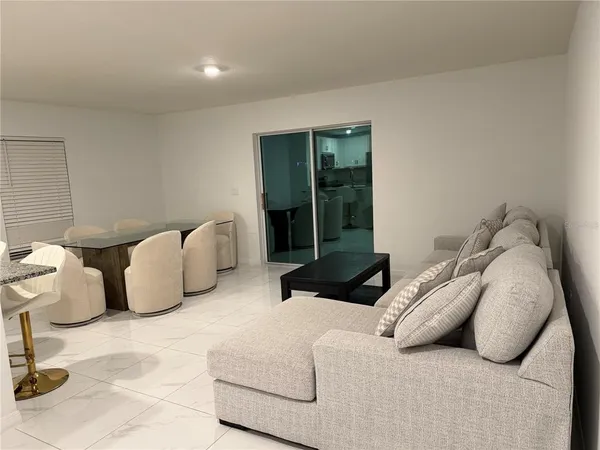 a bedroom with furniture and a large window