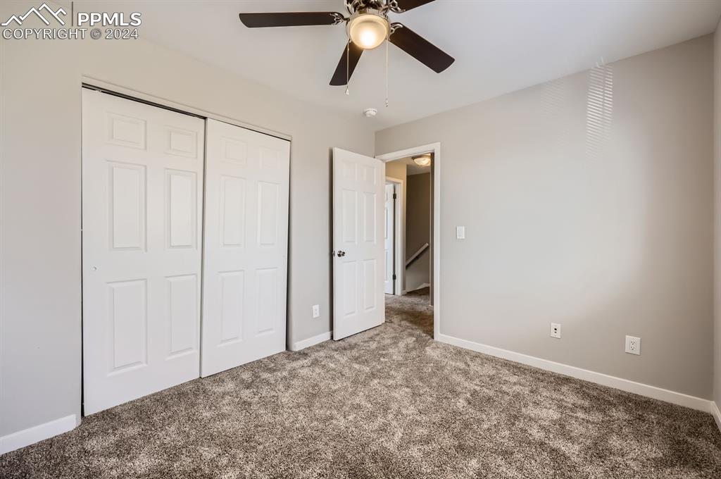 359 Ellers Grove Colorado Springs, CO 80916 - Photo 23 of 27 Unfurnished bedroom featuring carpet, ceiling fan, and a closet