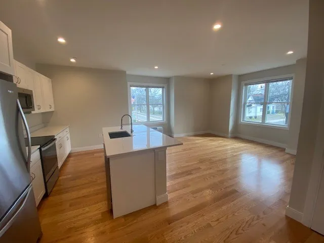 a kitchen with stainless steel appliances a refrigerator sink and microwave