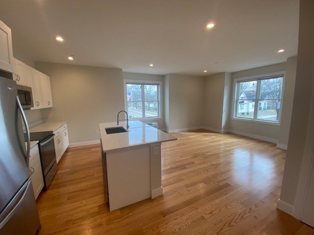 208 Neponset Valley Parkway, Unit 5 Boston, MA 02136 - Photo 2 of 9 a kitchen with stainless steel appliances a refrigerator sink and microwave