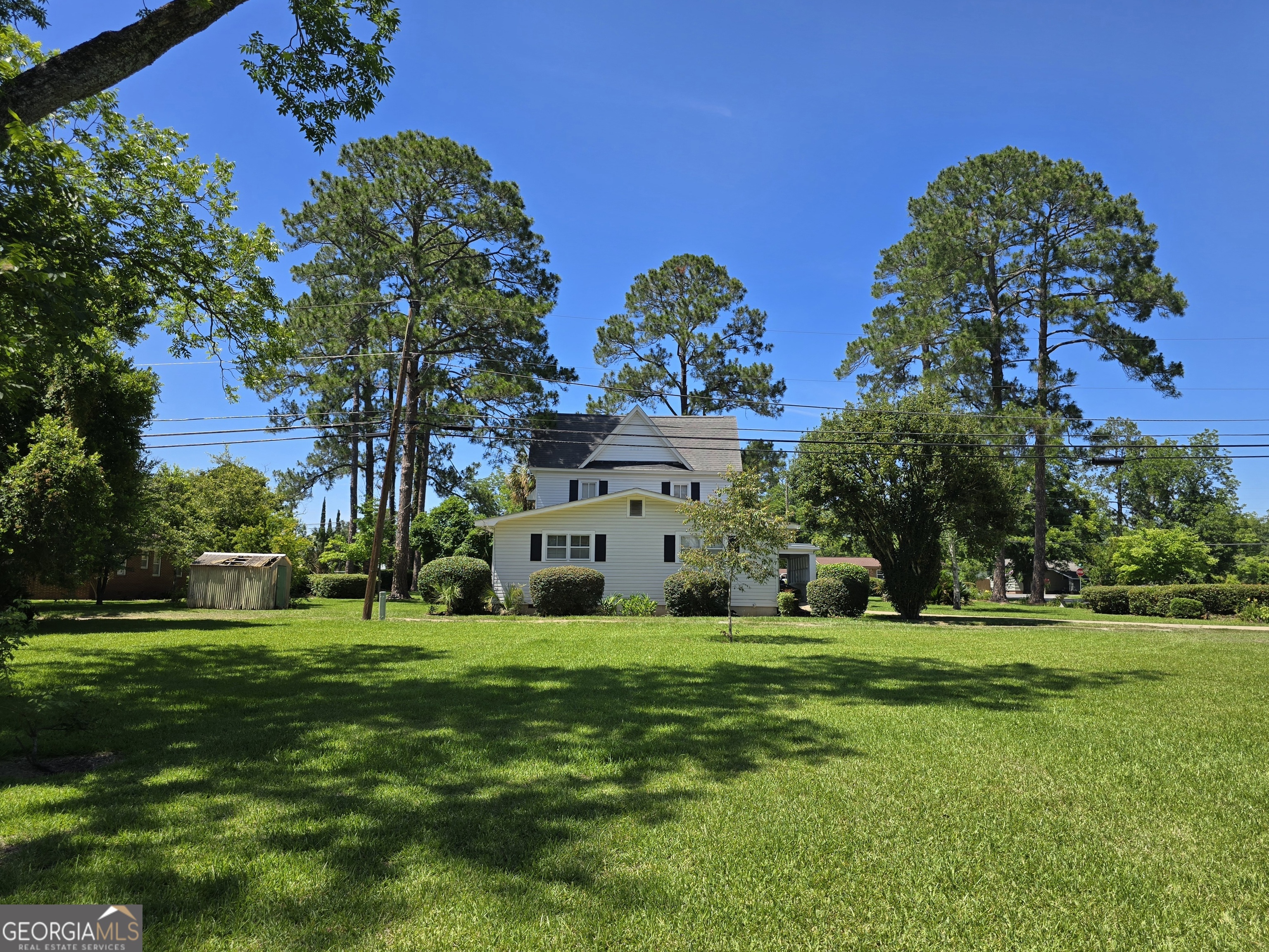 156 10 Mile Road Fitzgerald, GA 31750 - Photo 36 of 43 a large building with a big yard and large trees