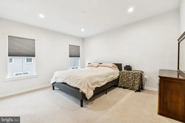 a spacious bedroom with a bed and a couch