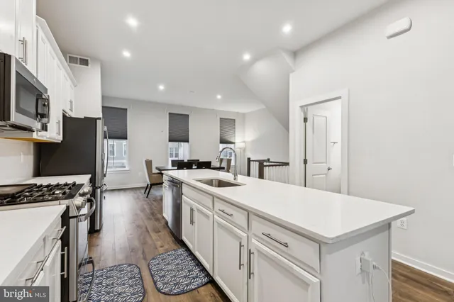 a kitchen with a stove a sink and a refrigerator