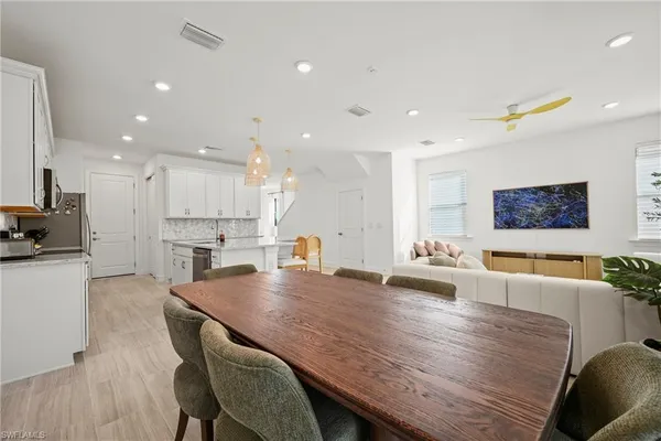 a large kitchen with a table and chairs in it