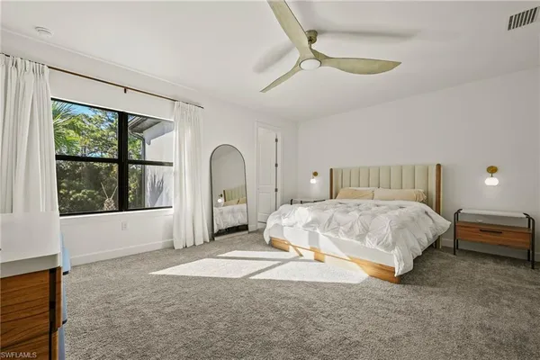 a bed sitting in a room next to a window
