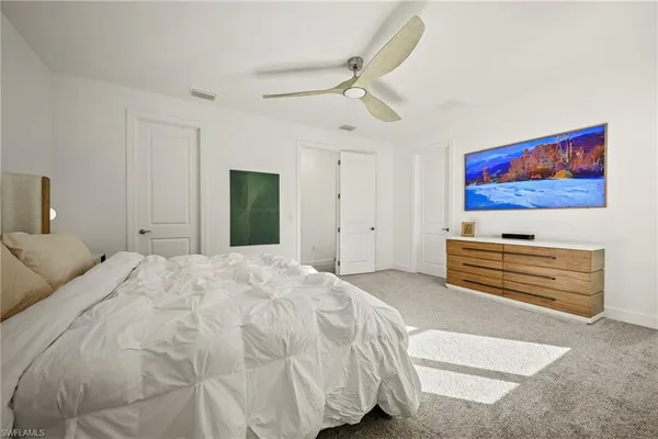 a bedroom with a bed and a chandelier