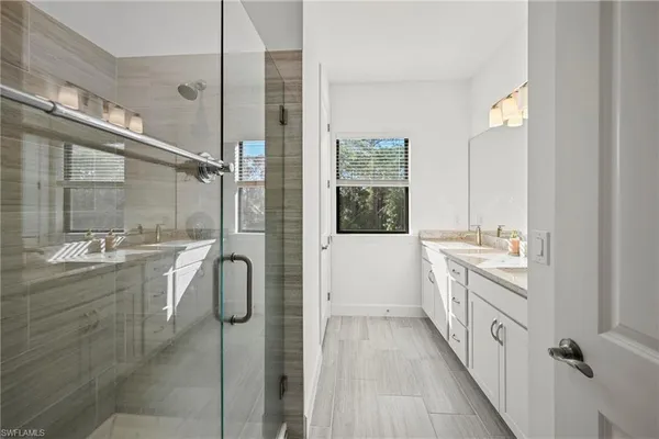 a bathroom with a granite countertop sink a toilet and shower