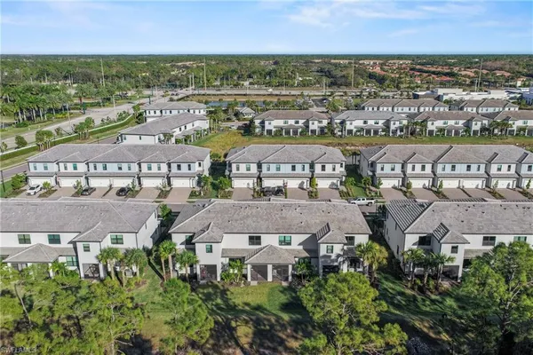 an aerial view of residential houses with city view
