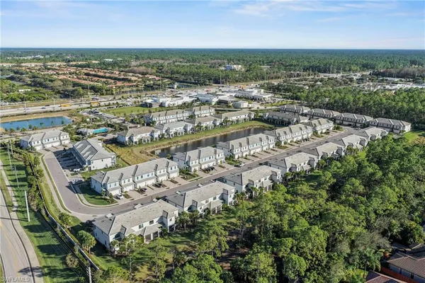 an aerial view of residential building and lake