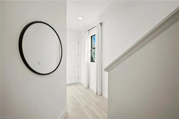 a view of a livingroom with car parked and door