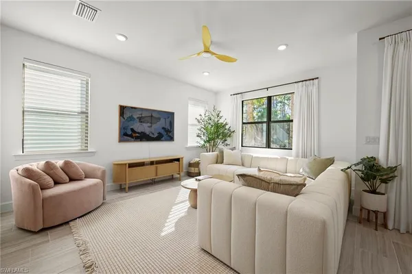 a living room with furniture and a large window