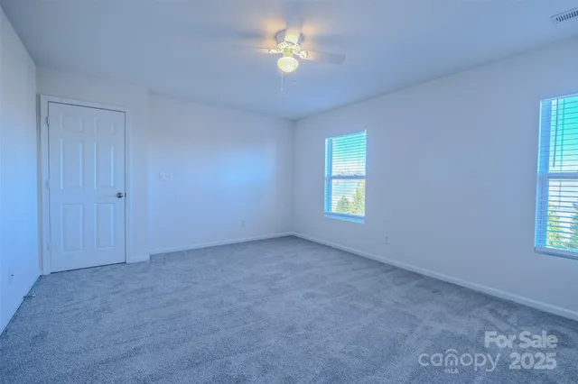 an empty room with closet and a window