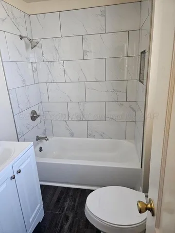 a bathroom with a toilet and bathtub