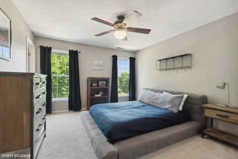 a bedroom with a bed dresser and a window