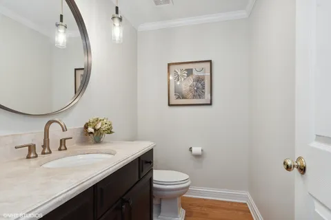 a bathroom with a granite countertop sink mirror and toilet