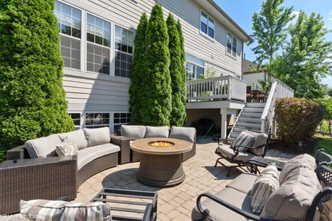 a view of a patio with couches chairs and a fire pit