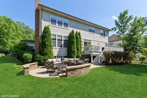 a view of a house with backyard sitting area and garden