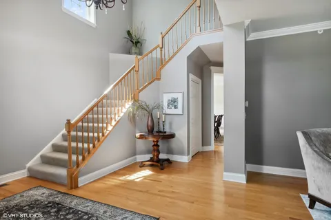 a view of entryway and hall with wooden floor