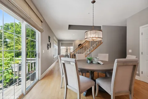 a dining room with furniture a chandelier and wooden floor