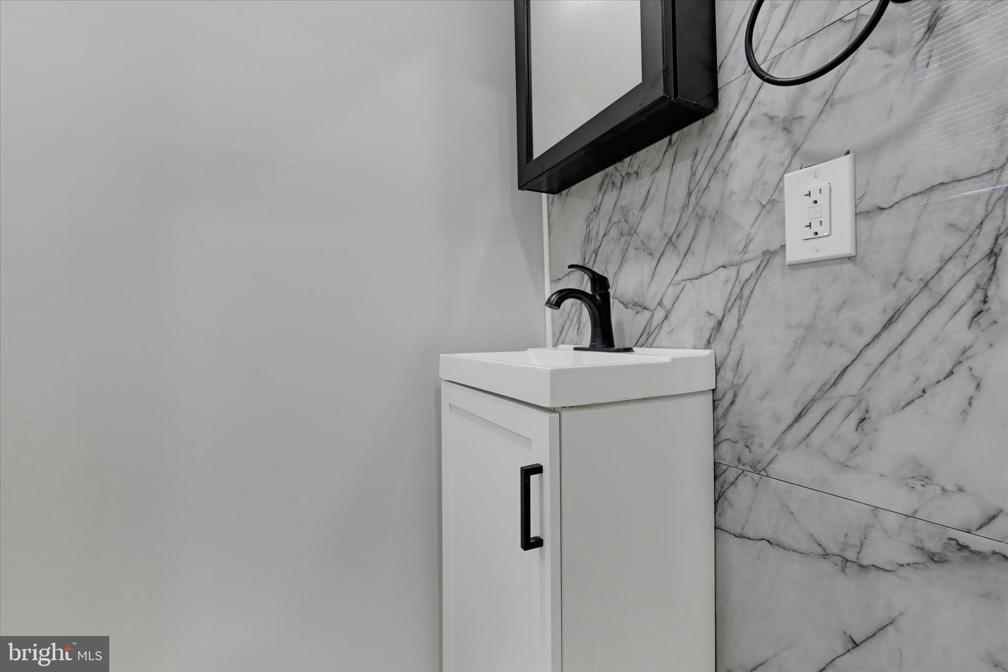 531 Wilson Street Baltimore, MD 21217 - Photo 12 of 24 a bathroom with a sink and mirror