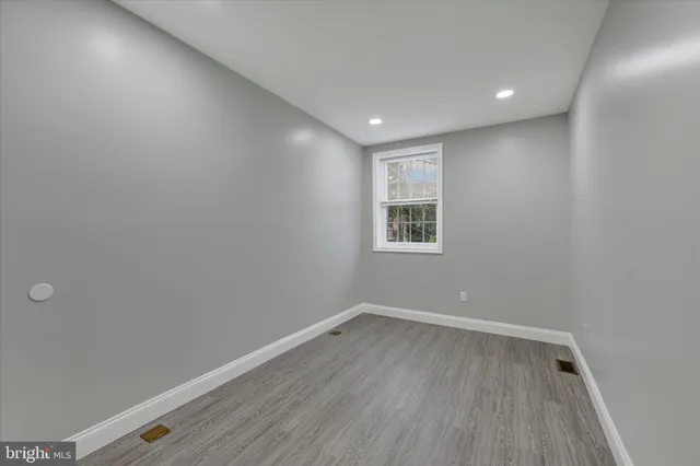 a view of room with window and wooden floor