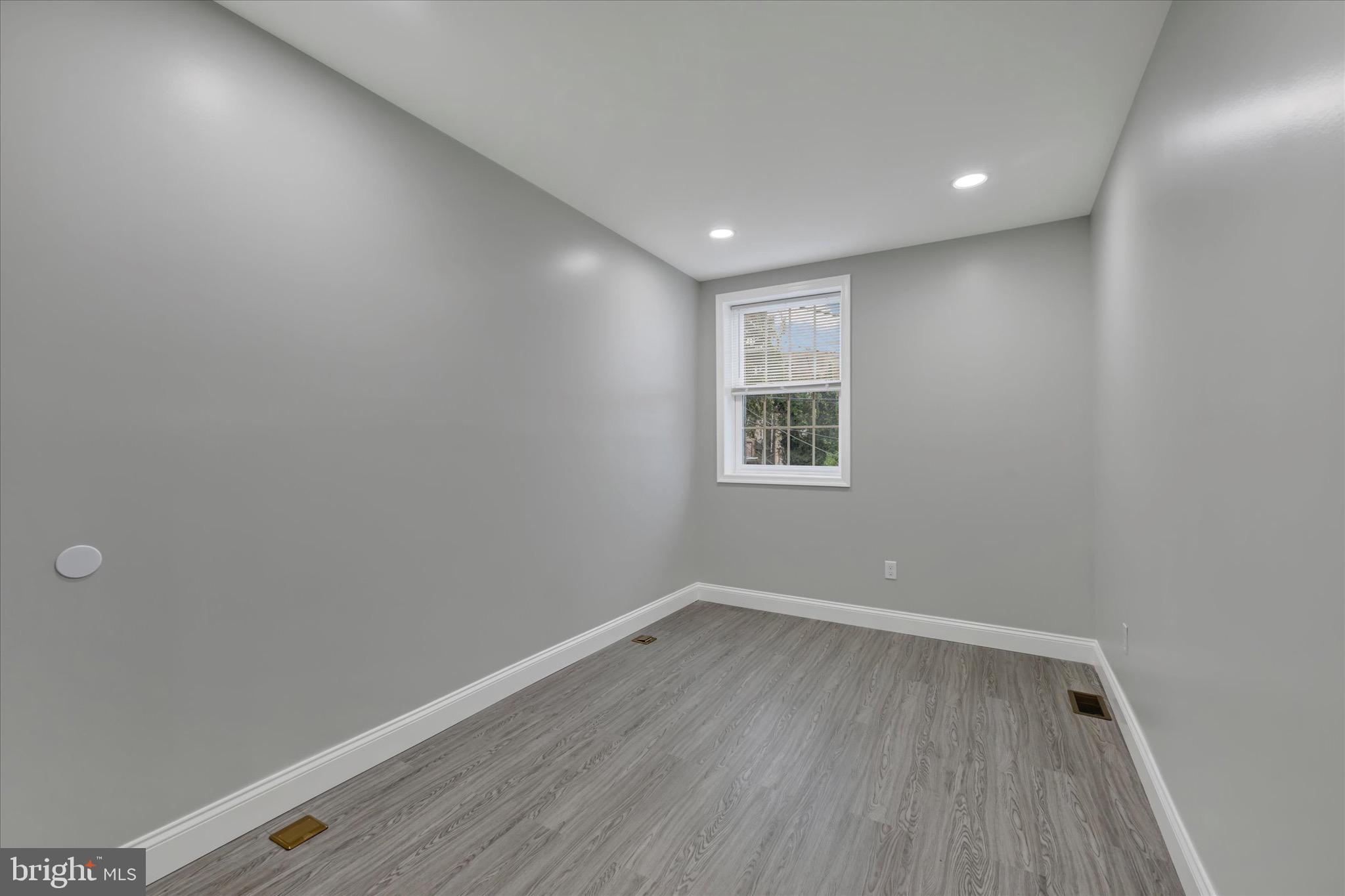 531 Wilson Street Baltimore, MD 21217 - Photo 14 of 24 a view of room with window and wooden floor