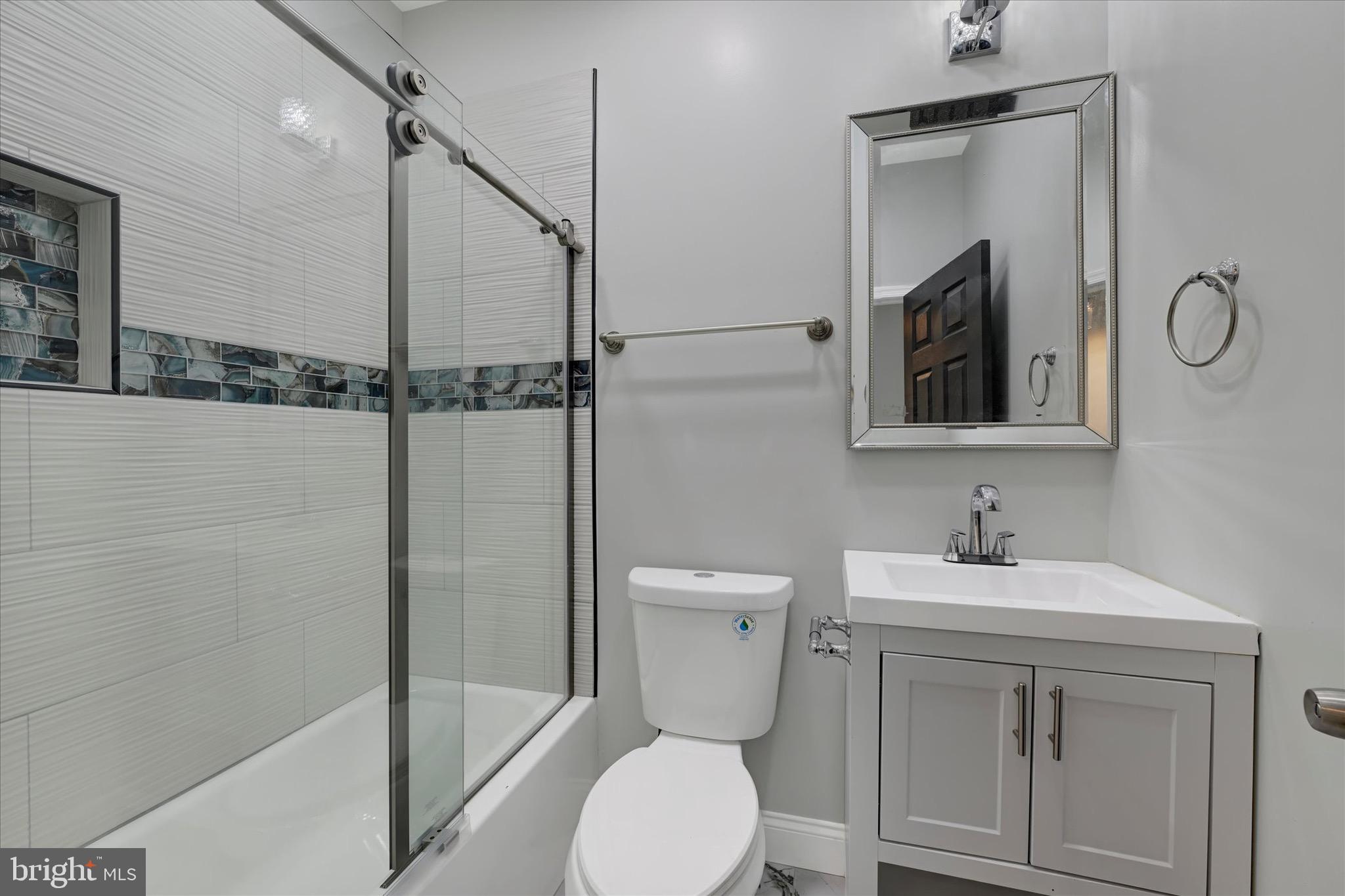 531 Wilson Street Baltimore, MD 21217 - Photo 17 of 24 a bathroom with a toilet sink vanity granite and shower