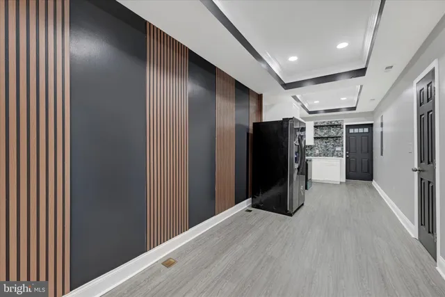a view of a refrigerator in kitchen and wooden floor