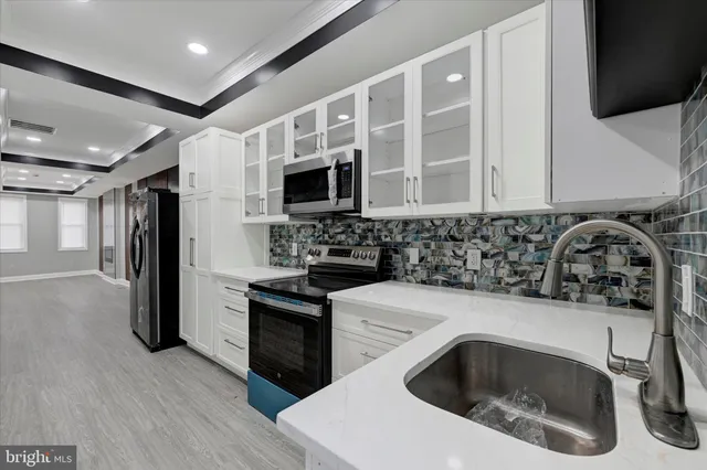 a kitchen with a sink stove and refrigerator
