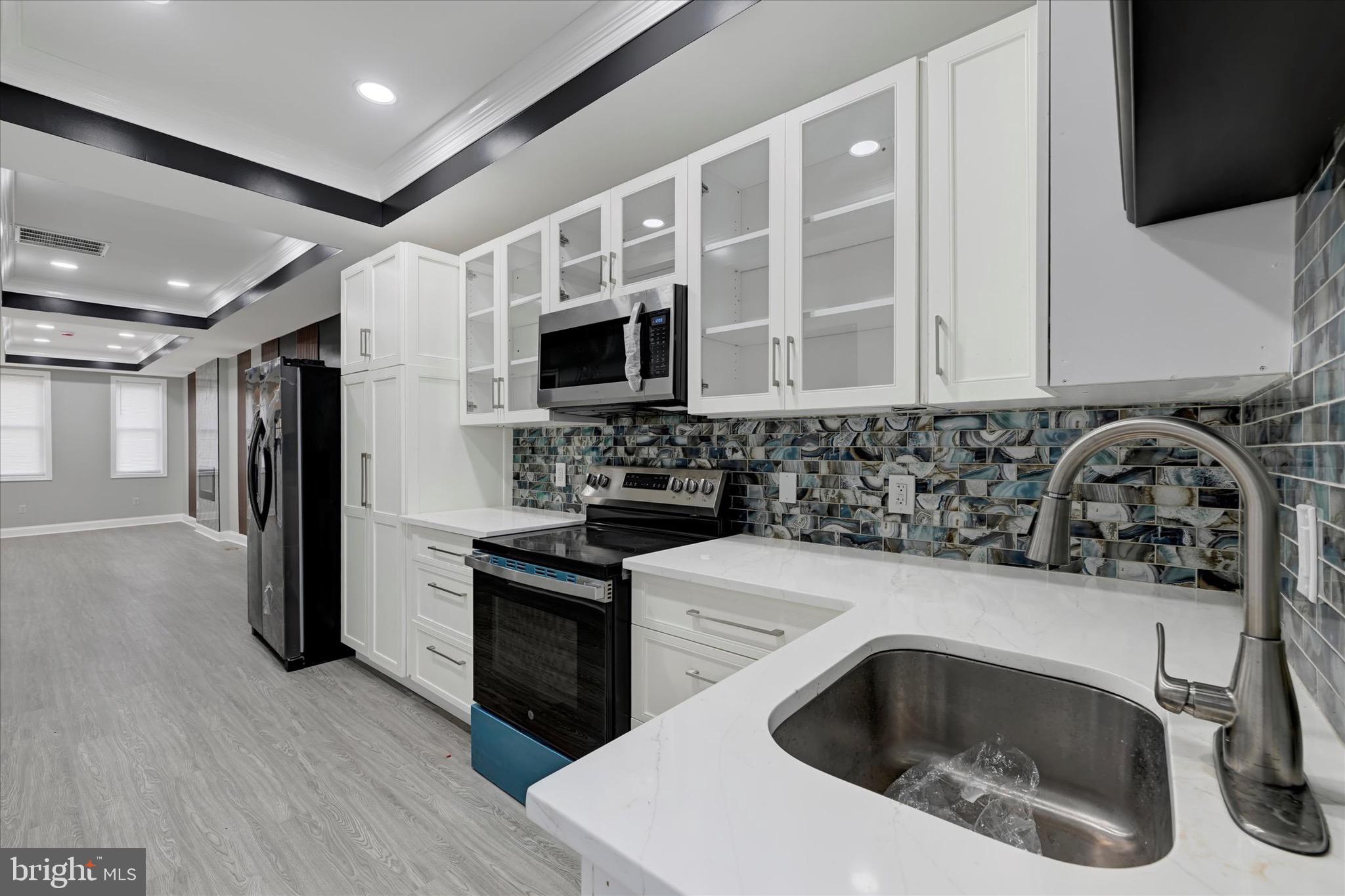 531 Wilson Street Baltimore, MD 21217 - Photo 10 of 24 a kitchen with a sink stove and refrigerator